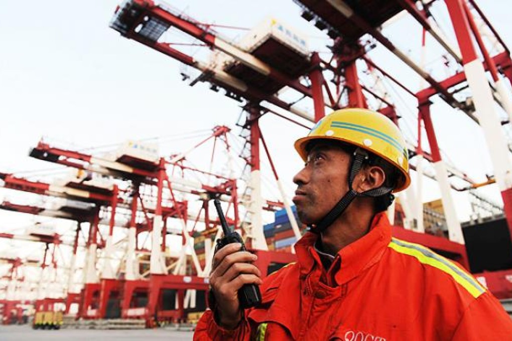 Containers are unloaded at Qingdao port, Shandong province. Photo: AFP