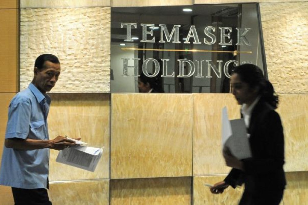 Temasek Holdings, Singapore state-linked investment firm, owns 16 per cent in Olam International. (AFP PHOTO/ROSLAN RAHMAN)