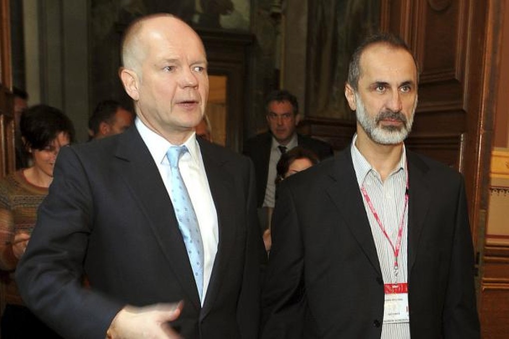 William Hague (left) with newly-formed opposition bloc leader Ahmed Moaz al-Khatib, just before a Whitehall meeting on November 16. Photo: AP