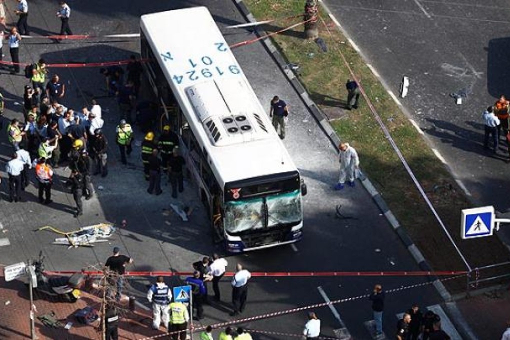 Rescue workers examine the scene after a bus was bombed in central Tel Aviv on Wednesday. Photo: EPA