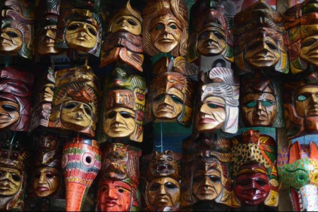 Wooden masks are offered to tourists at a handicrafts market in Chichicastenango municipality, Quiche department, 167 km west of Guatemala City, on November 15, 2012. Photo: AFP