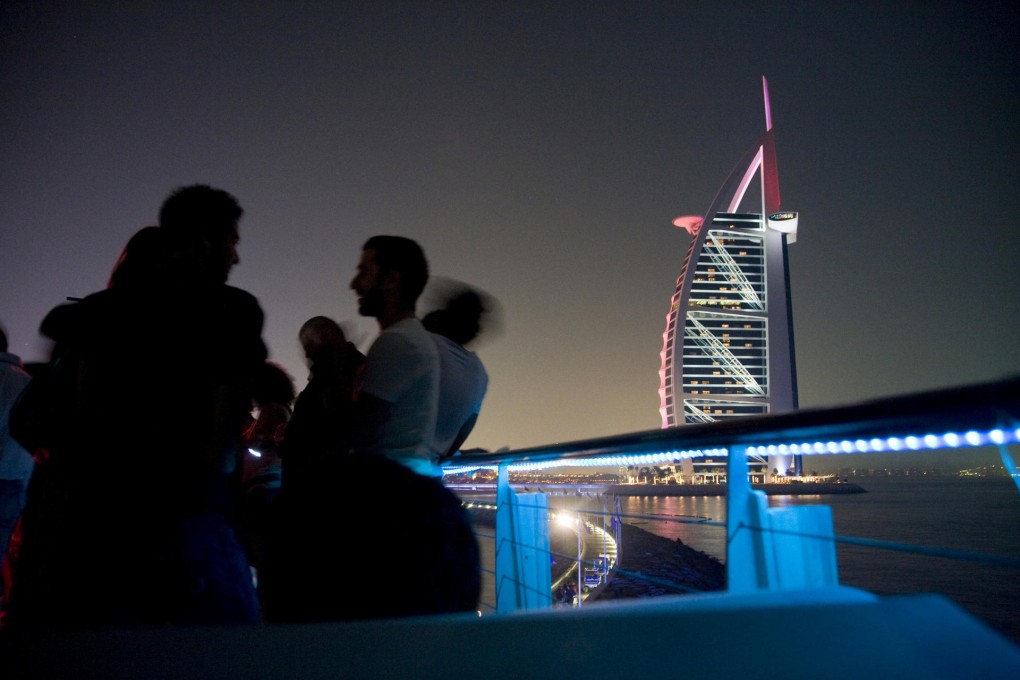 Above: the view from 360 bar at the Jumeirah Beach Hotel. From far left: preparing cocktails at Mahiki; revellers pack the dance floor; the view from At.mosphere, the world's highest restaurant and bar. Photos: Corbis