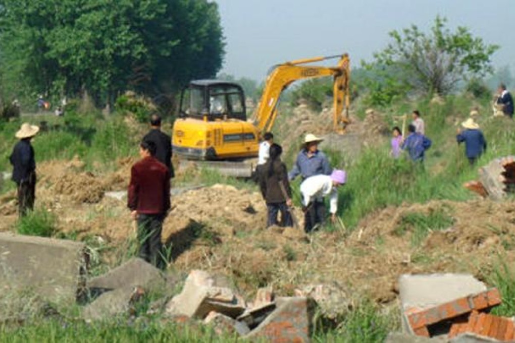 Graves are removed to make way for farmland in Zhoukou city, Henan. Photo: SCMP