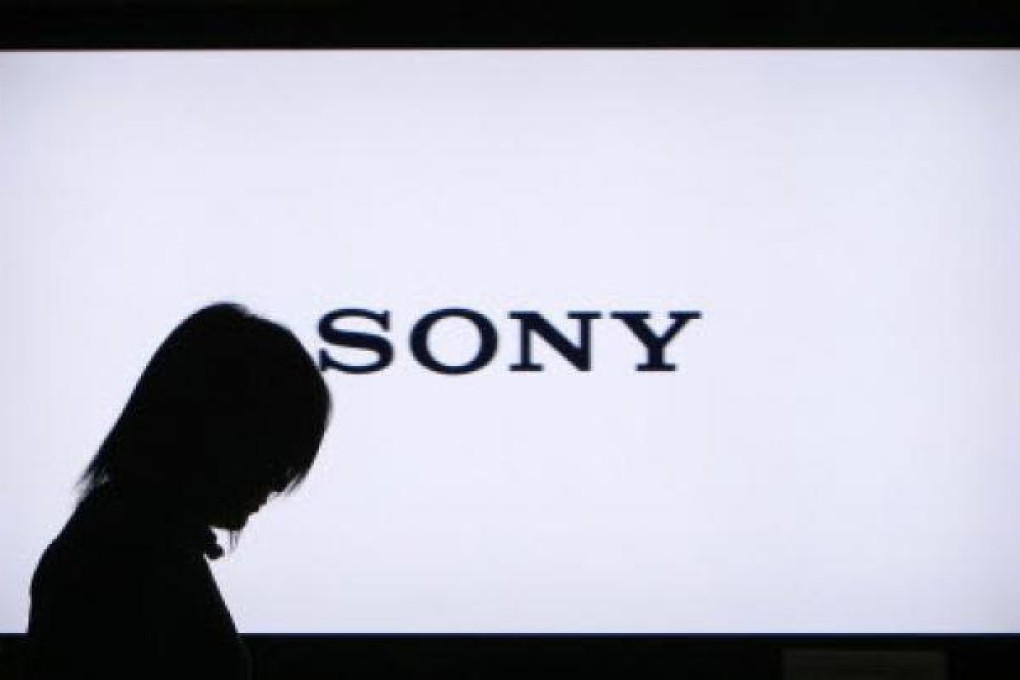 A woman walks past a Sony Corp flat-screen TV at the company's headquarters in Tokyo. Photo: Reuters