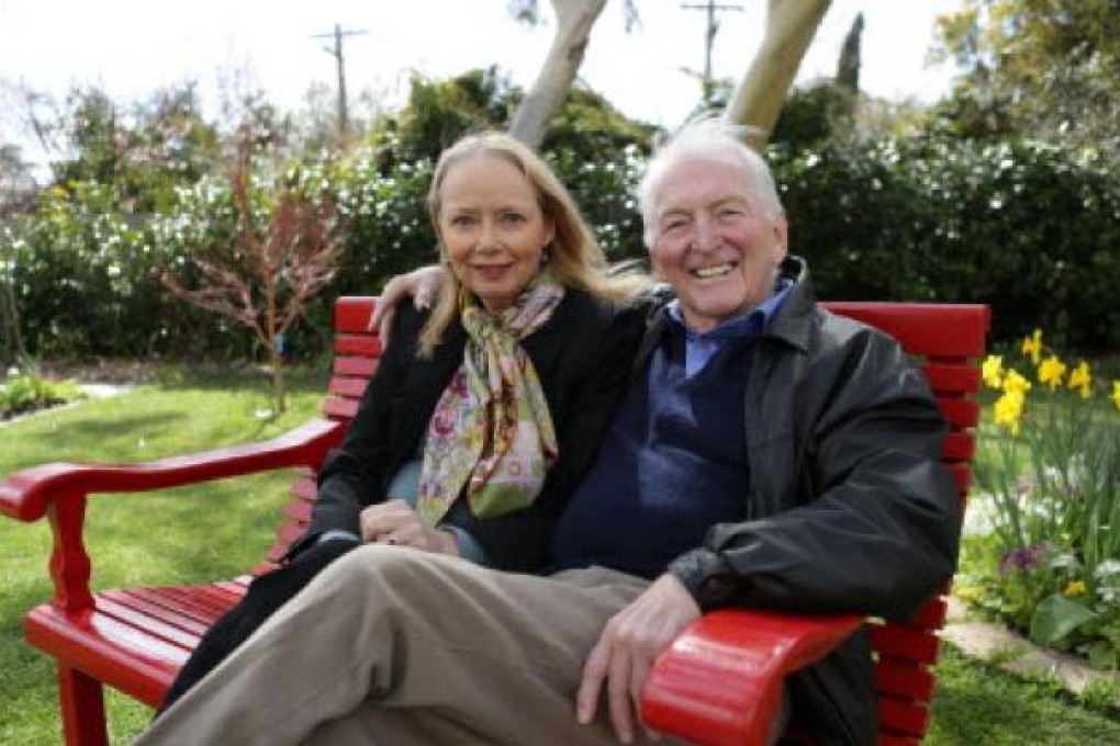 Australian best-selling author Bryce Courtenay poses with wife Christine Gee on a park bench in Canberra Australia Courtenay. Photo: AP