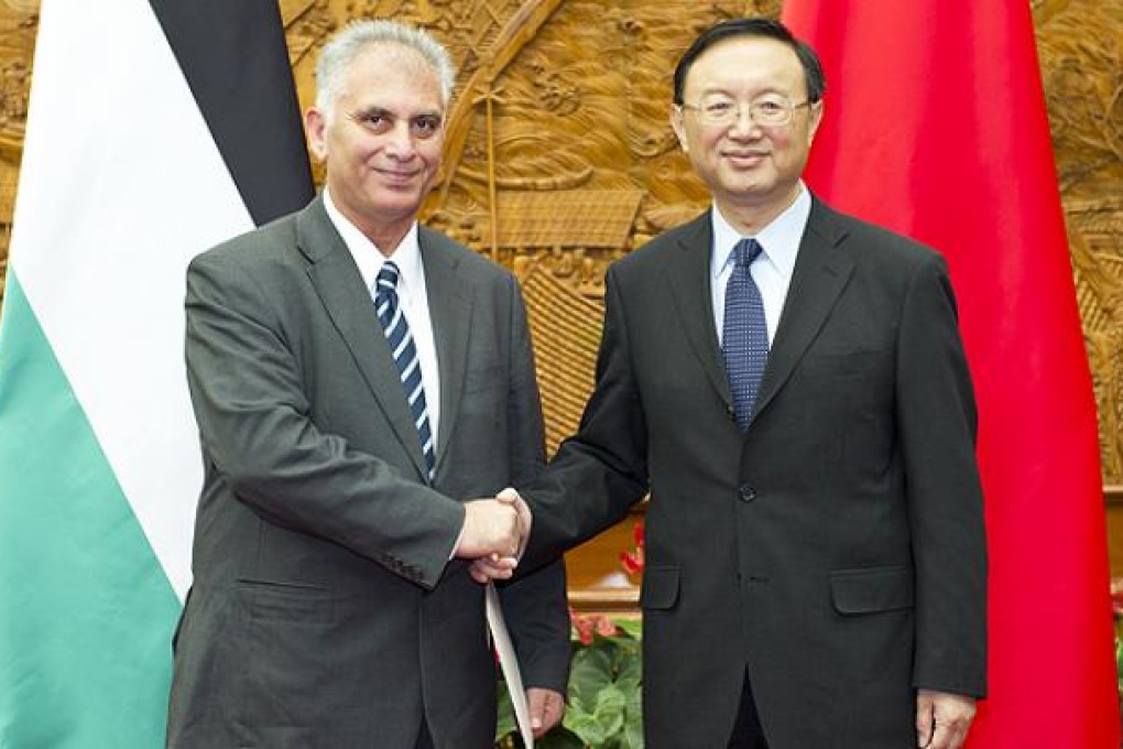 General Secretary of the Palestinian People’s Party, Bassam al-Salhi, greets China's Foreign Minister Yang Jiechi in Beijing. Photo AFP