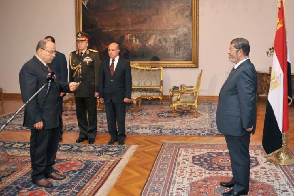 Egyptian President Mohammed Mursi (right) swearing in new Prosecutor-General Talaat Ibrahim (left) at the presidential palace in Cairo on Thursday. Photo: AFP