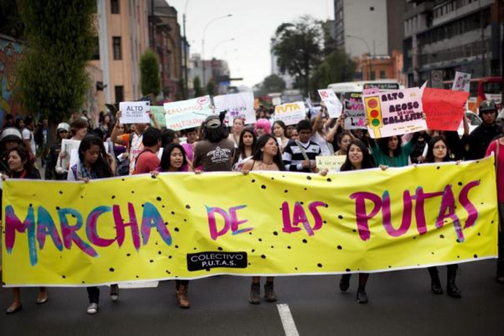 Woman march with a banner that reads in Spanish; "March of the Sluts" better known as SlutWalks, in Lima, Peru. Photo: AP