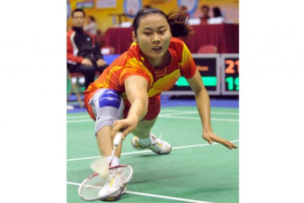 World number one Wang Yihan of China stoops down to reach the shuttlecock. Photo: Xinhua