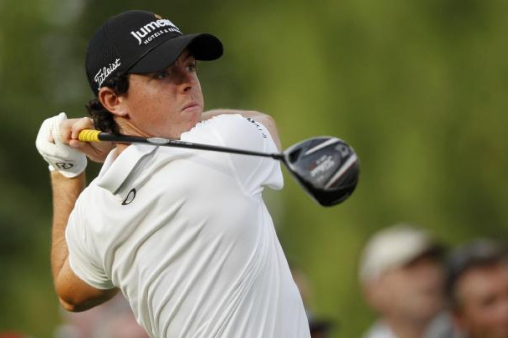 Rory McIlroy of Northern Ireland watches his shot on his way to sharing a three-way, second-round lead in Dubai. Photo: Reuters
