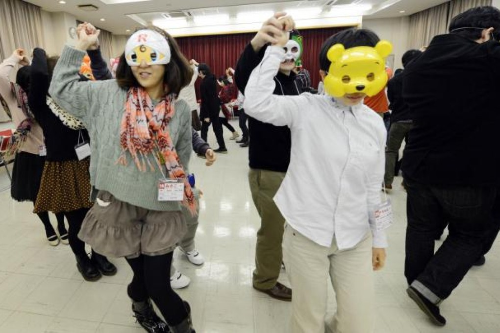 Self-confessed geeks join in a folk dance in Tokyo as part of a new form of match-making aimed at combating their shyness. Photo: AFP