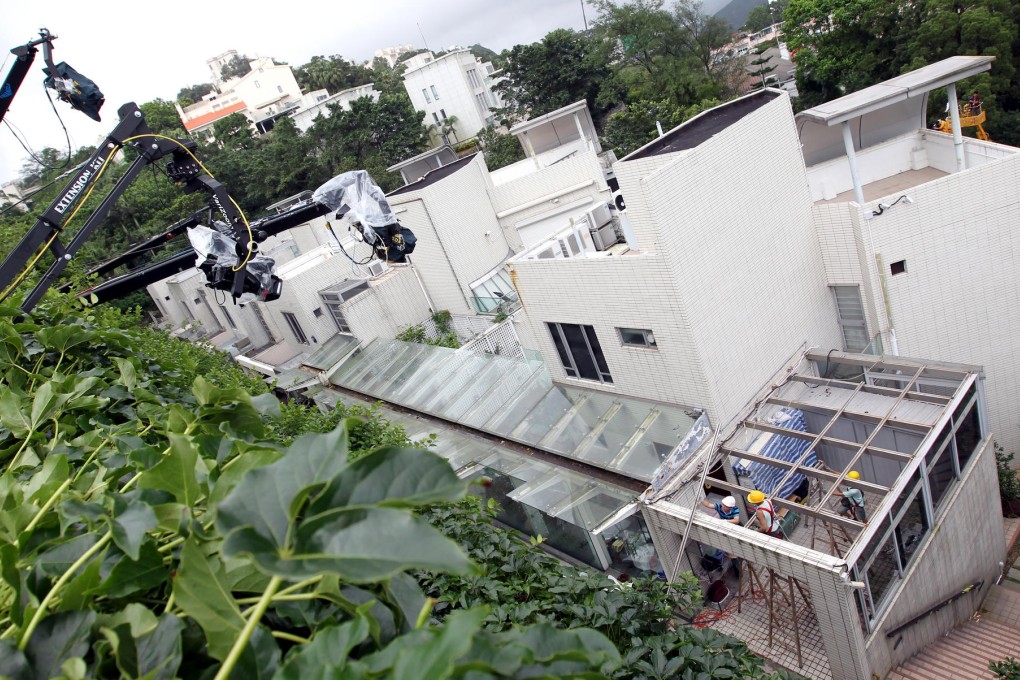 Press photographers hired cranes in June to get a better view of Leung Chun-ying's Peak houses. Photo: Dickson Lee