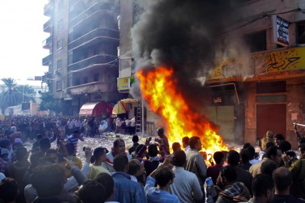 Protesters storm an office of Egyptian President Mohammed Mursi's Muslim Brotherhood Freedom and Justice party and set fires in the Mediterranean port city of Alexandria. Photo: AP