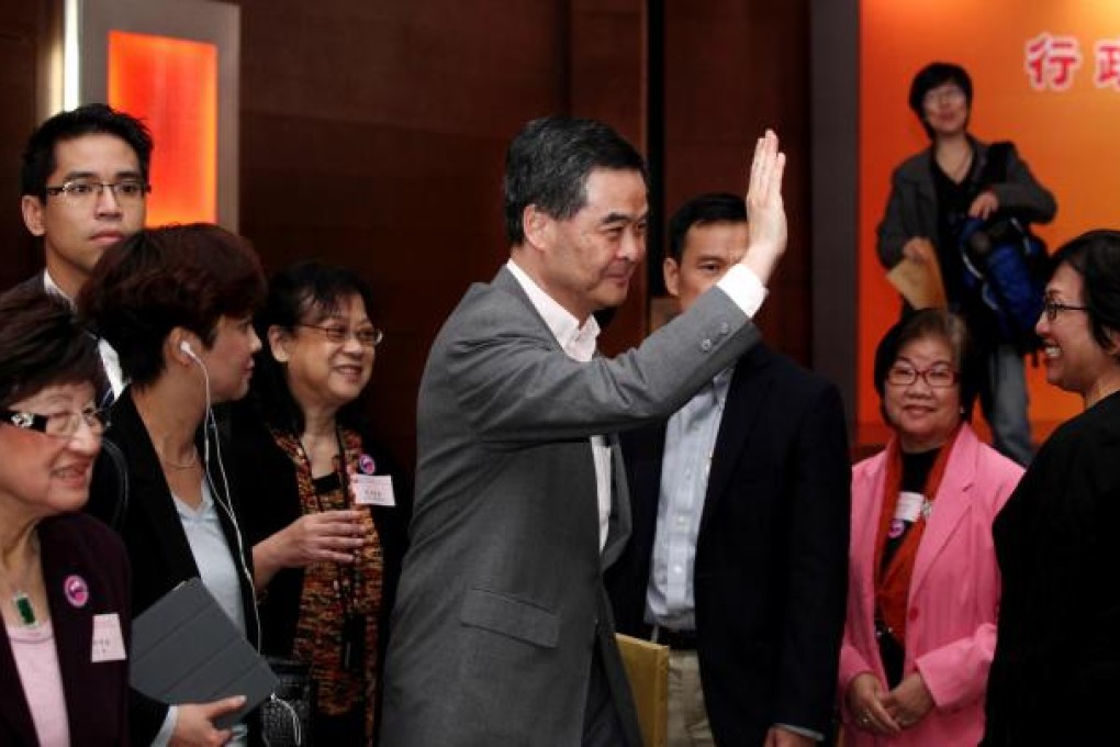 Chief Executive Leung Chun-ying waves as he attends a meeting organised by Hong Kong Federation of Women. Photo: Thomas Yau