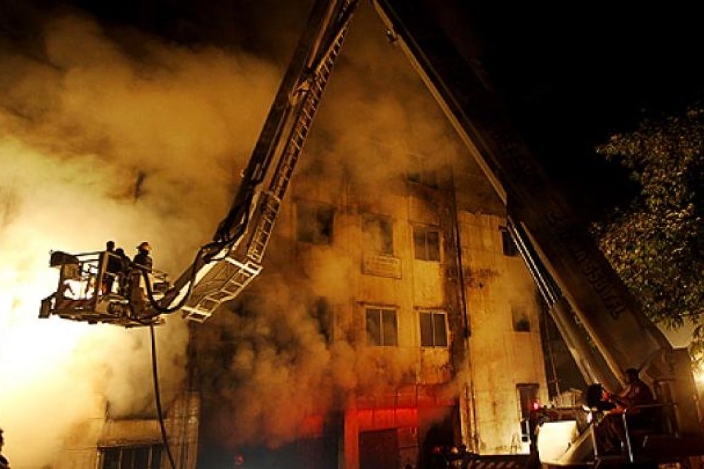 Bangladeshi firefighters battle a fire at a garment factory in the Savar neighborhood in Dhaka. Photo: AP
