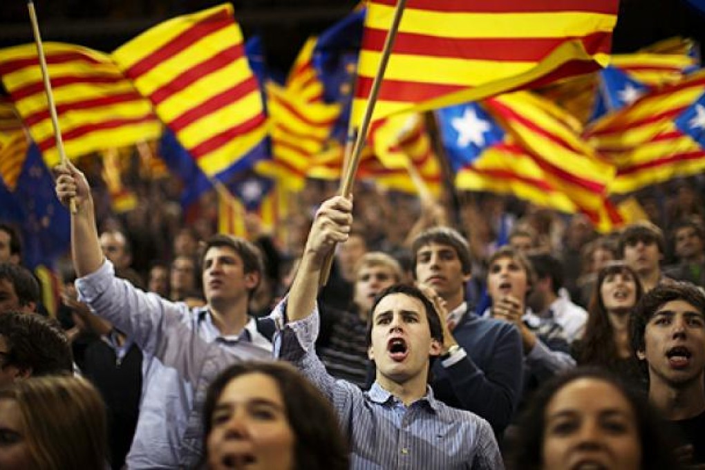 Supporters of Artur Mas wave pro-independence flags in Barcelona on Friday. Photo: AP