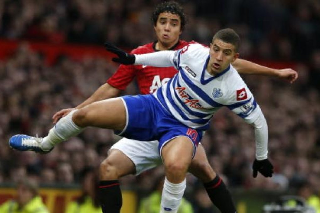 Manchester United's Rafael da Silva (back) challenges Queens Park Rangers' Adel Taarbat in their match at Old Trafford. Photo: Reuters