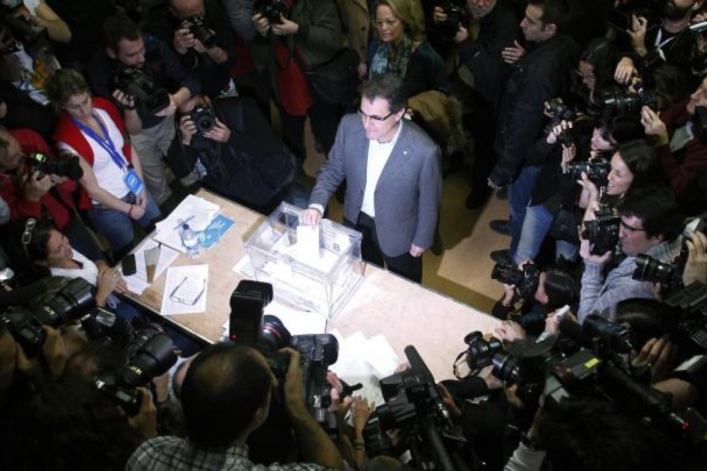 Convergencia i Unio leader Artur Mas votes in Sunday's ballot. His alliance is seeking a consultation on secession from Spain. Photos: Reuters