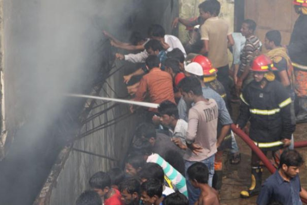 Firefighters and local people try to extinguish a fire at a garment factory in Dakkhin Khan in Dhaka on Monday. Photo: Xinhua
