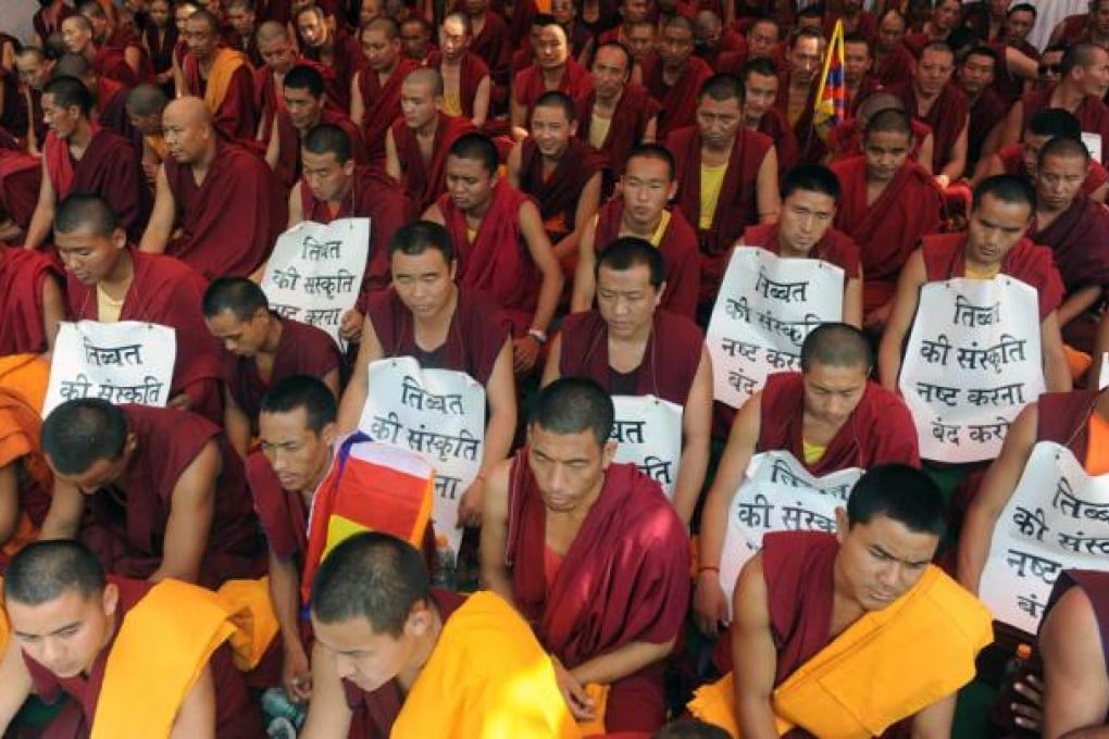 Tibetan monks at a sit-in in India yesterday to push for freedom in their homeland. The rally came a day after a nun, the first woman to do so, self-immolated against harsh Chinese rule. Photo: AFP