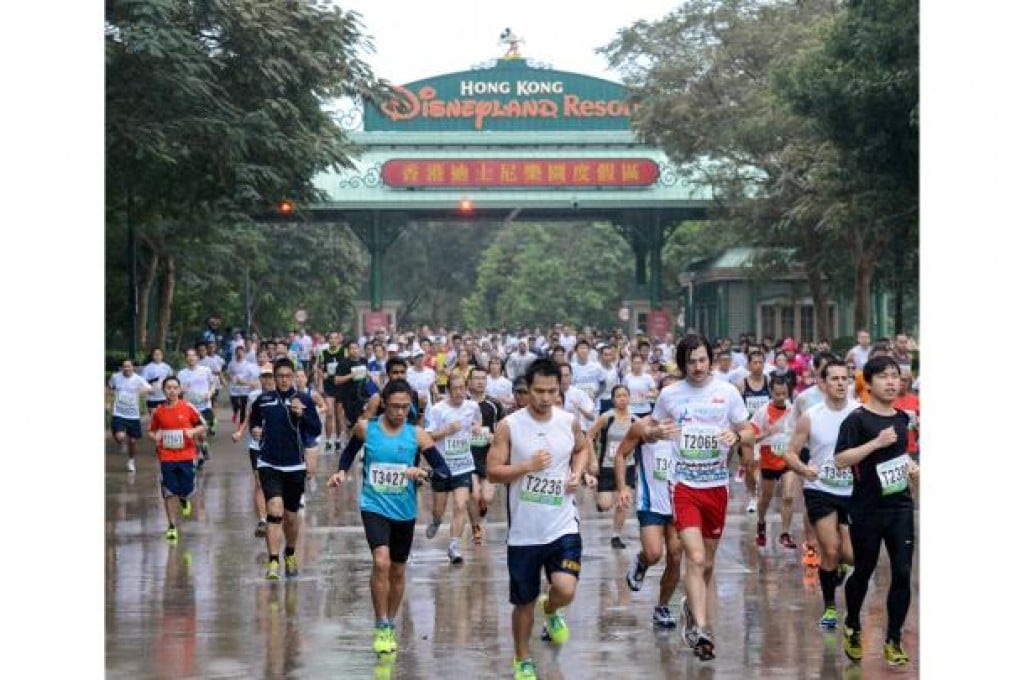 Runners in the Unicef Charity Run's 10km event begin the race in wet conditions. Photo: Richard Castka