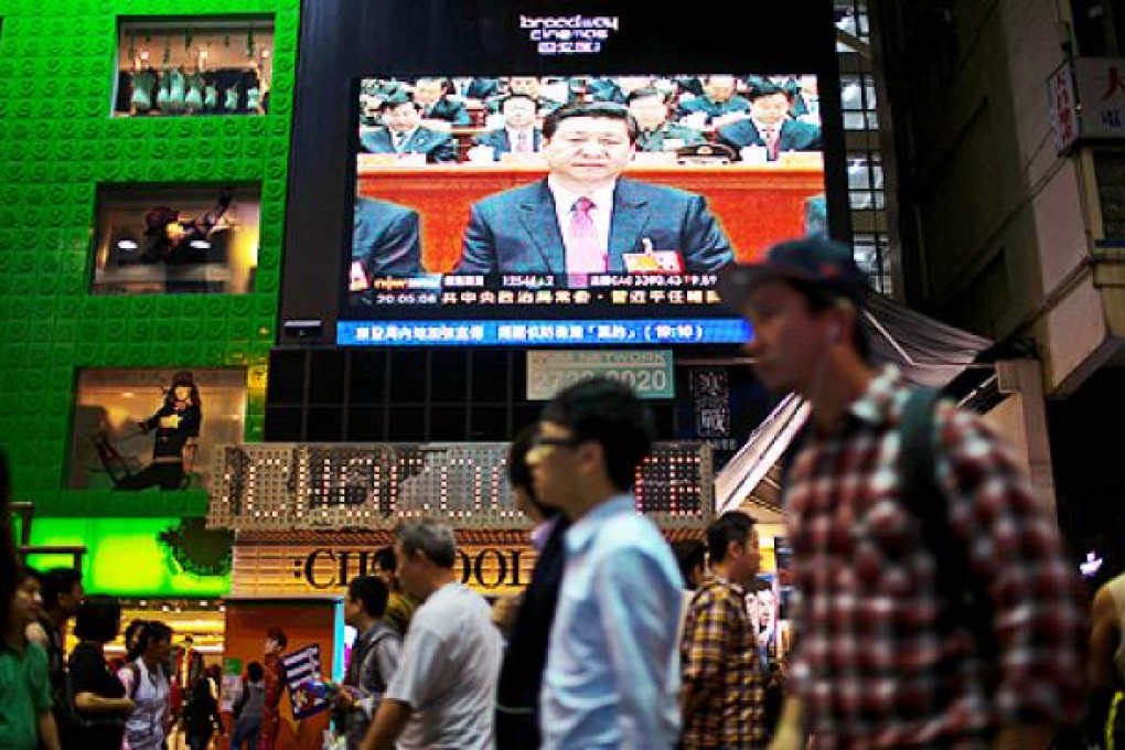 China's next leader Xi Jinping is seen on a television screen in the shopping district of Mong Kok. Photo: Bloomberg