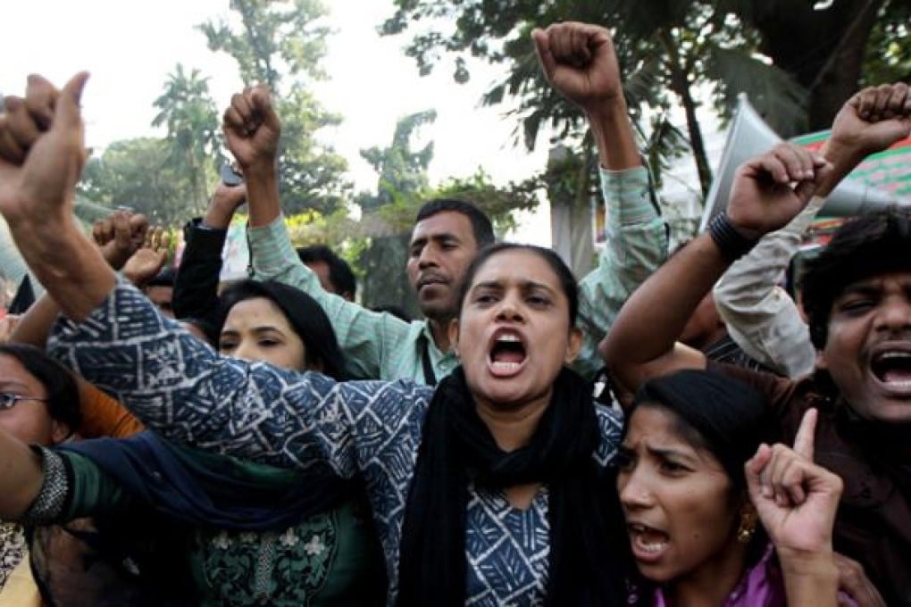 Bangladeshi garment workers shout slogans during a protest in Dhaka on Tuesday, following a deadly fire in a garment factory. Photo: AFP