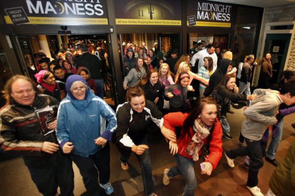 Black Friday shoppers pour into the Valley River Center mall for the Midnight Madness sale Friday. Photo: AP