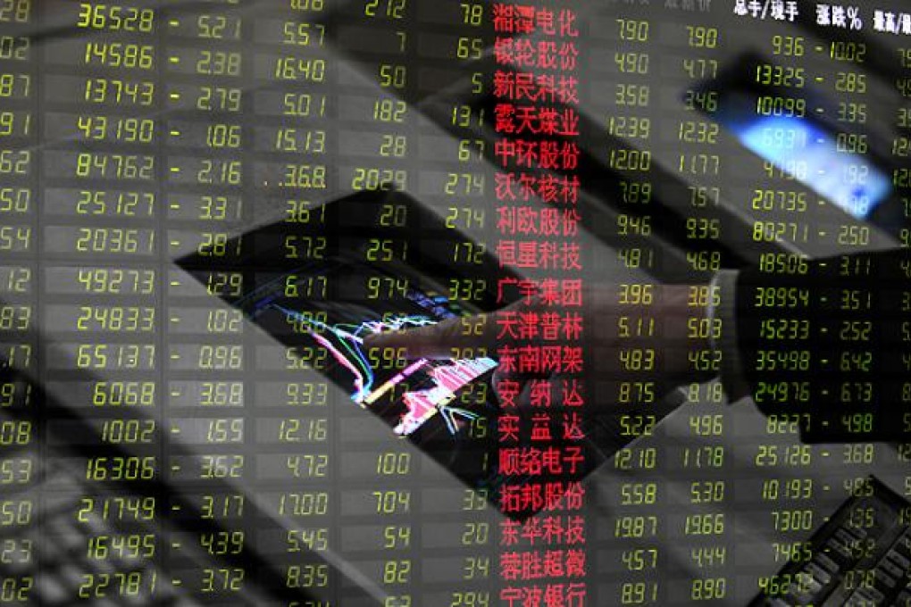 An investor checks stocks at a trading hall in Hangzhou on Thursday. Photo: Xinhua