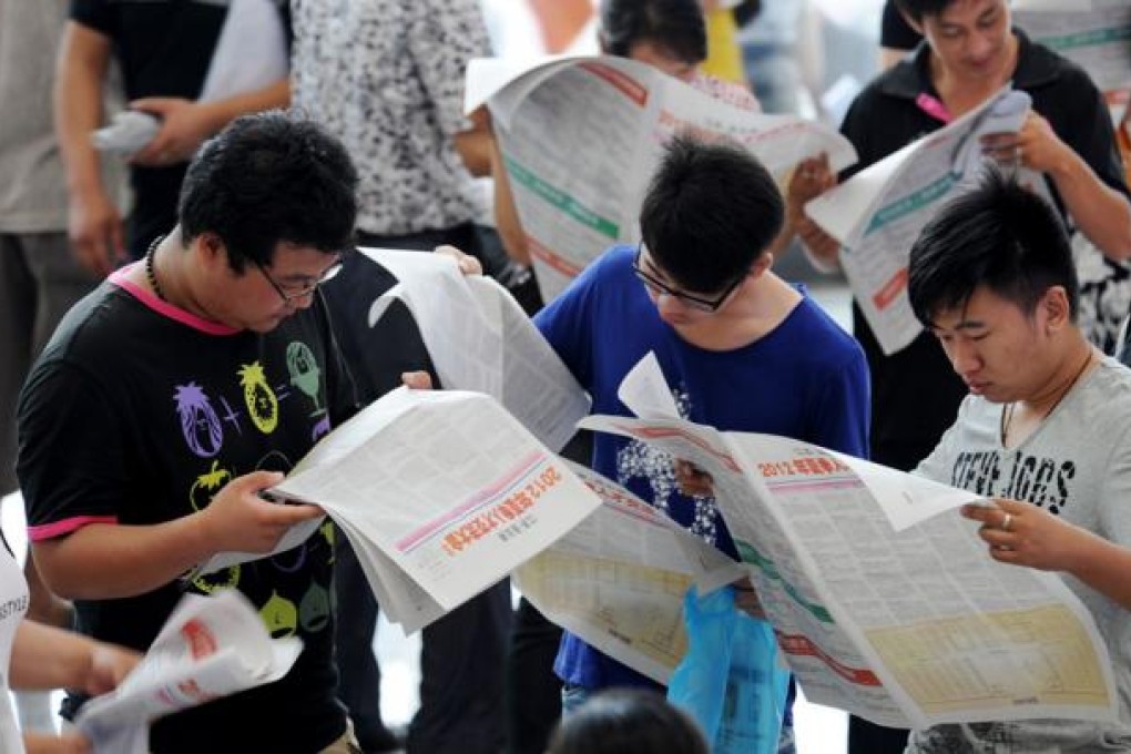 Job seekers read want ads during a job fair in China. Rapid output growth could be explained entirely by rapid growth in inputs of labour and capital. Photo: Xinhua