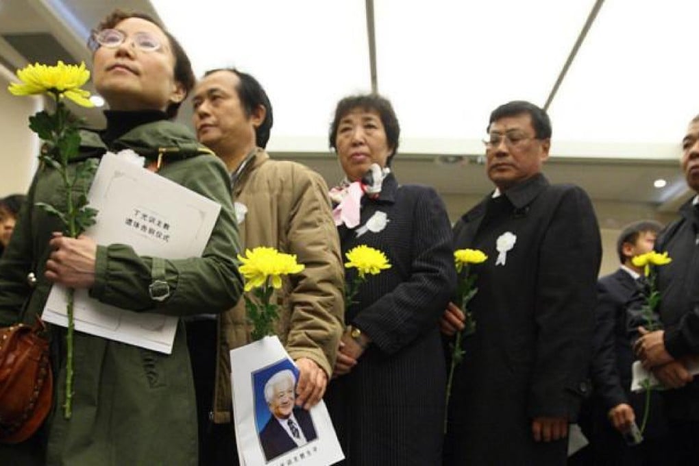 People attend the funeral of Bishop Ding Guangxun, a controversial religious and political figure.