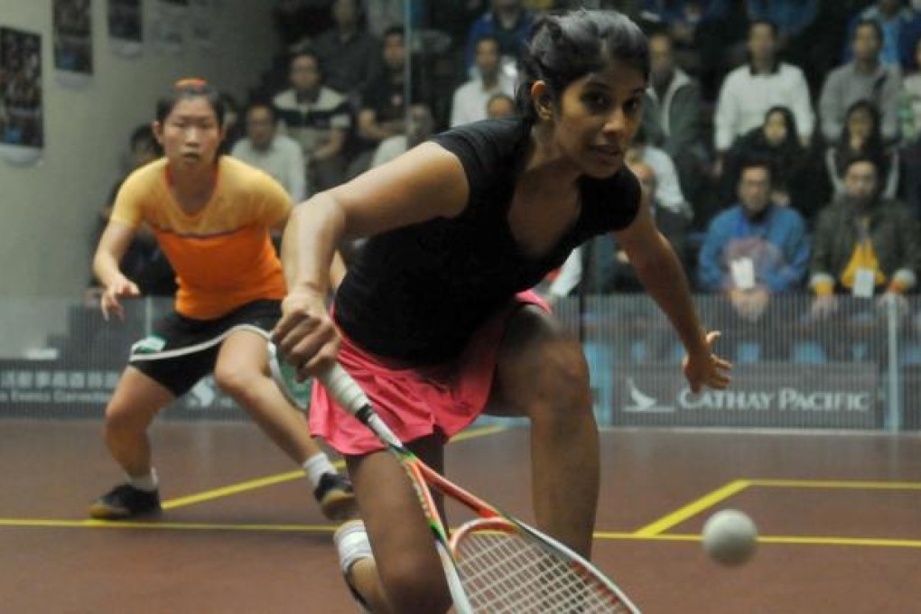 Joshana Chinappa reaches for a ball at the tin as Annie Au looks on during her shock loss. Photo: Xinhua