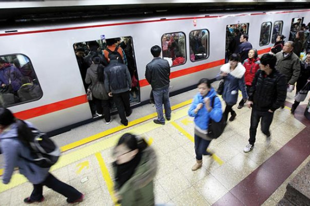 Commuters at a subway station in Beijing. Photo: Bloomberg