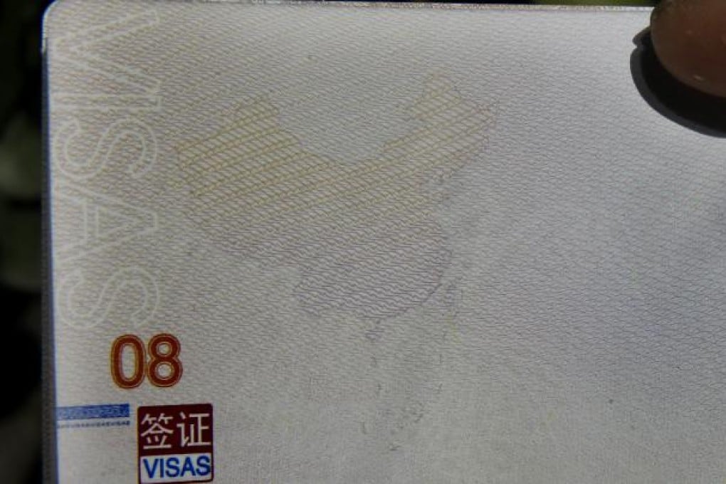 A page from a Chinese passport shows a Chinese map which demarcates the South China Sea inside a 'nine-dash line' as part of the Chinese territory. Photo: AP