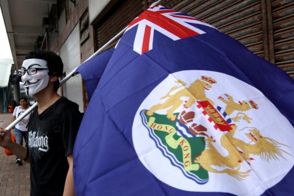 Members of "We are Hongkongers, Not Chinese" wave Hong Kong Flag of the colonial era in front of Central Government's Liason Office in Western District on 1st October 2012, the National Day of China. Photo: Dickson Lee
