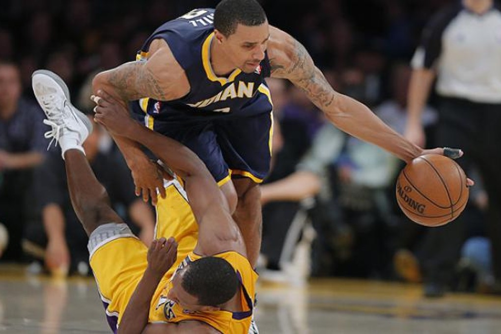 Indiana Pacers' George Hill grabs a loose ball against Los Angeles Lakers' Chris Duhon in Los Angeles. Photo: AP