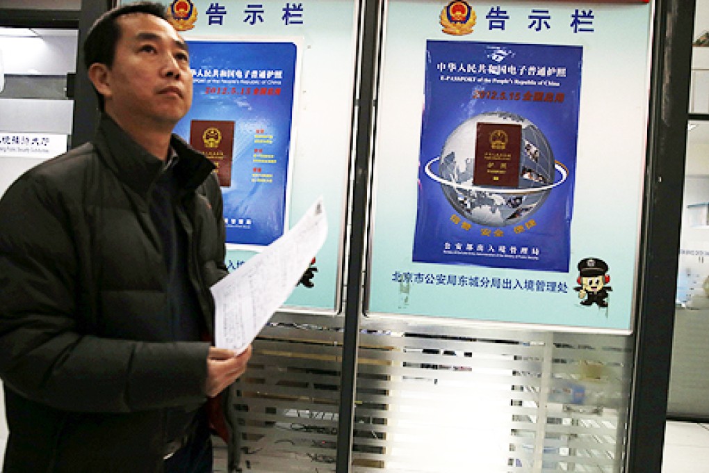 Signs at a passport office in Beijing announce new editions will be issued. Photo: AP