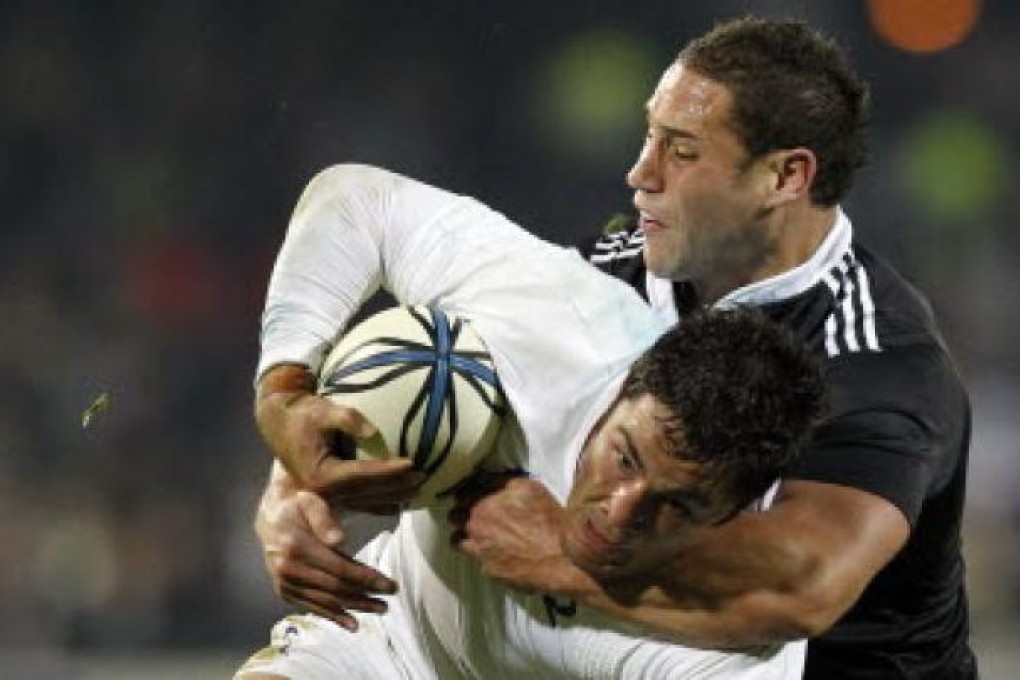 England's Brad Barritt being tackled by New Zealand Maori's Luke McAlister. Barritt insists his side can beat New Zealand. Photo: Reuters