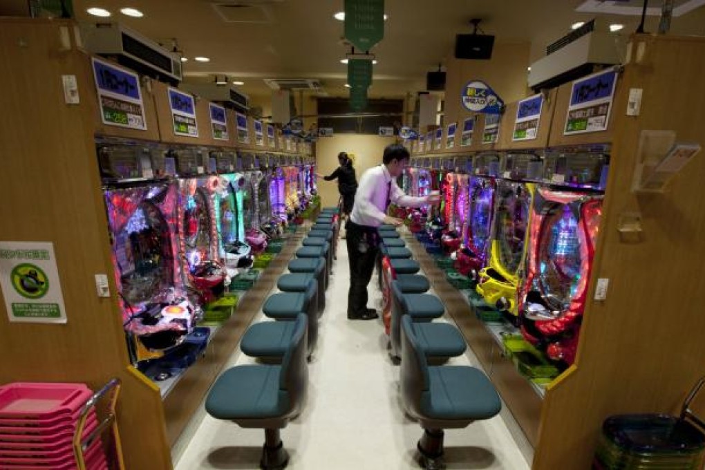 Dynam workers check pachinko machines in Tokyo. Photo: Bloomberg