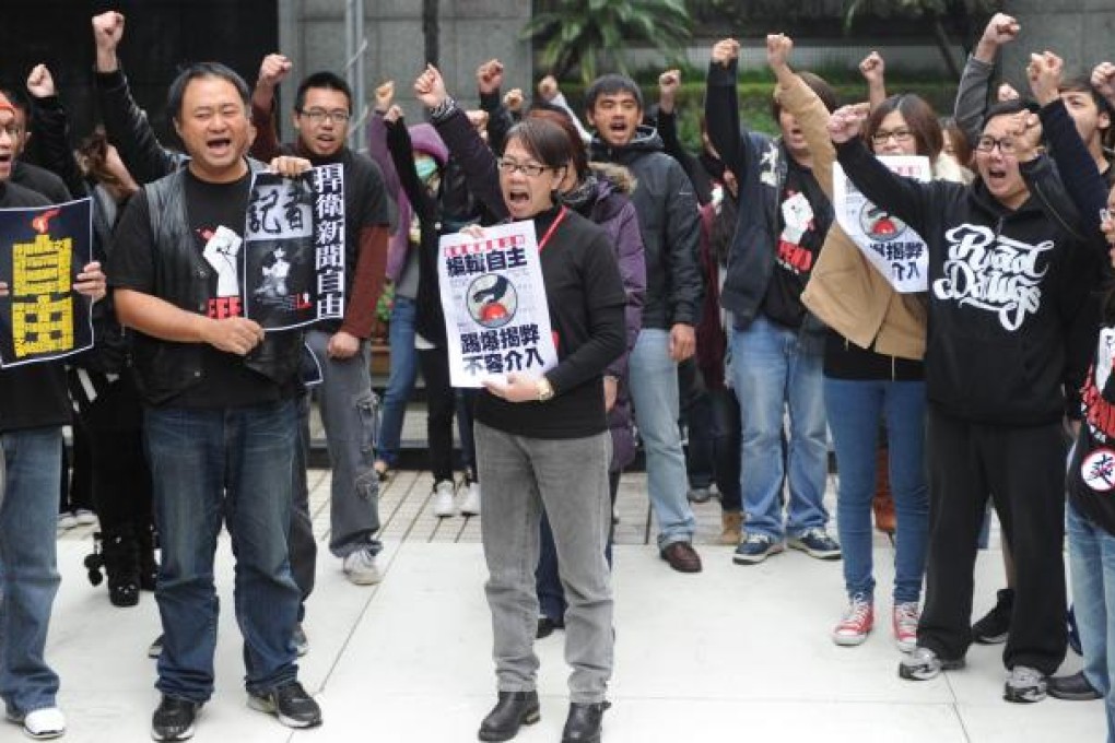Employees from Taiwan's Next Media demonstrate in Taipei on Tuesday against the sale but company representative Mark Simon says Next Media has been sold to good buyers. Photo: AFP