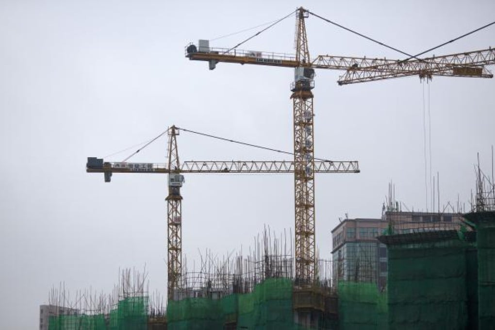 Cranes operate on the construction site of a residential building complex. Photo: EPA
