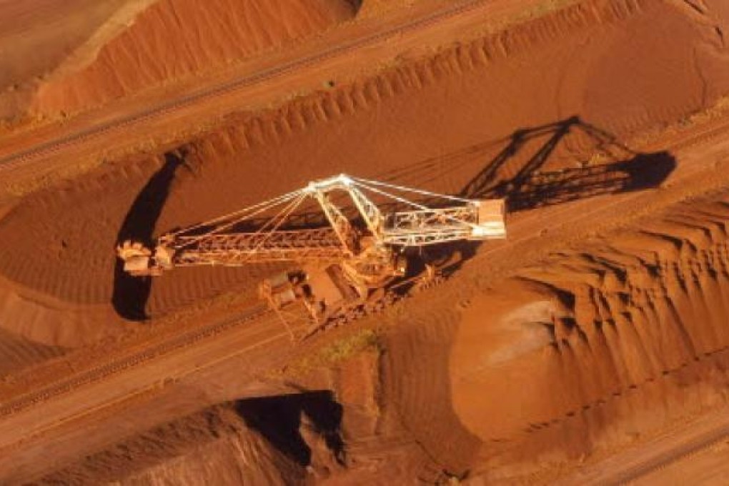 A bucket wheel reclaimer collects ore at the BHP Billiton iron ore loading facility in Perth, Australia. Photo: Reuters