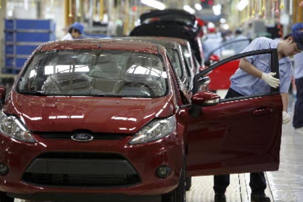 Workers operate the assembly line at the Changan Ford Mazda Plant in Nanjing. Photo: Bloomberg