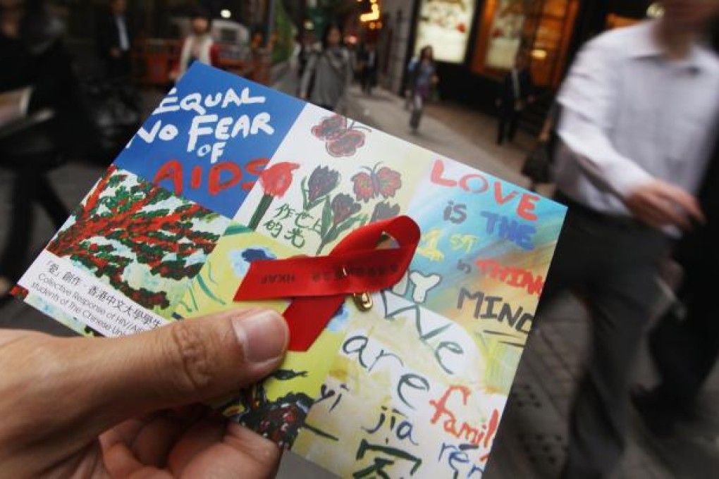 Members of Hong Kong AIDS Foundation hand out the red ribbons and leaflet to commemorate World Aids Day. Photo: Sam Tsang