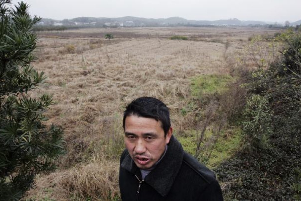 Luo Jianxiang, a villager of Shuangqiao village stands on the polluted farmland. Photo: Felix Wong