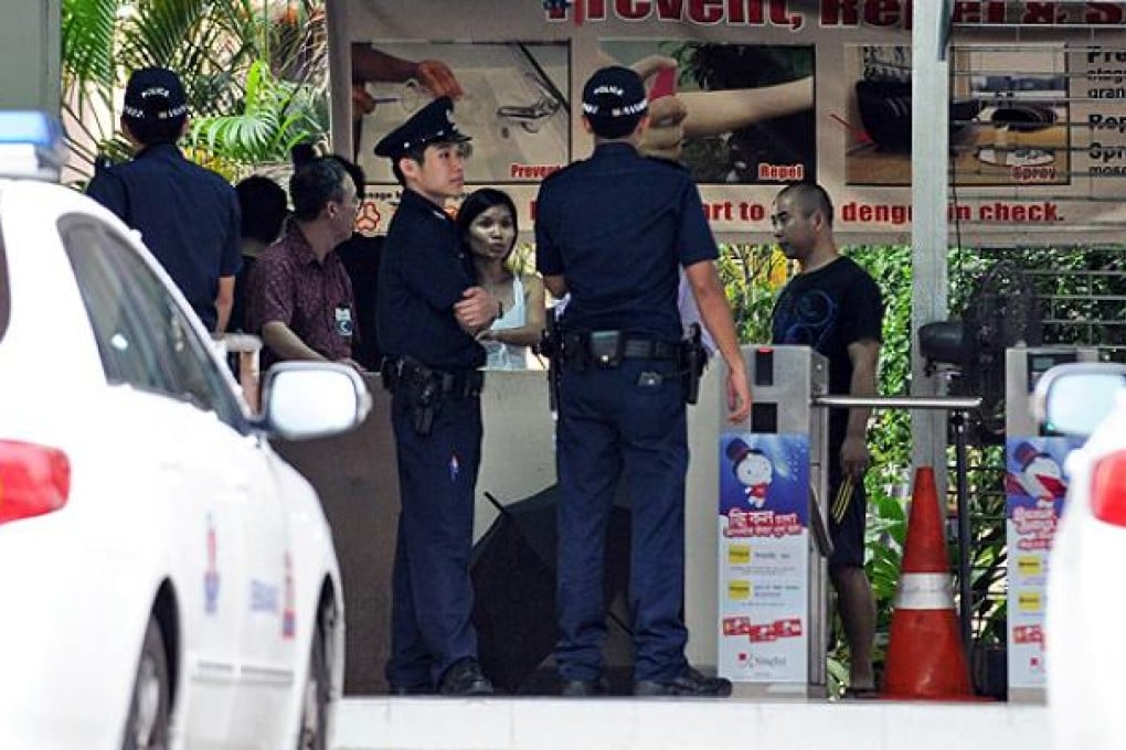 Singapore police make inquiries at a foreign workers dormitory. Photo: AFP