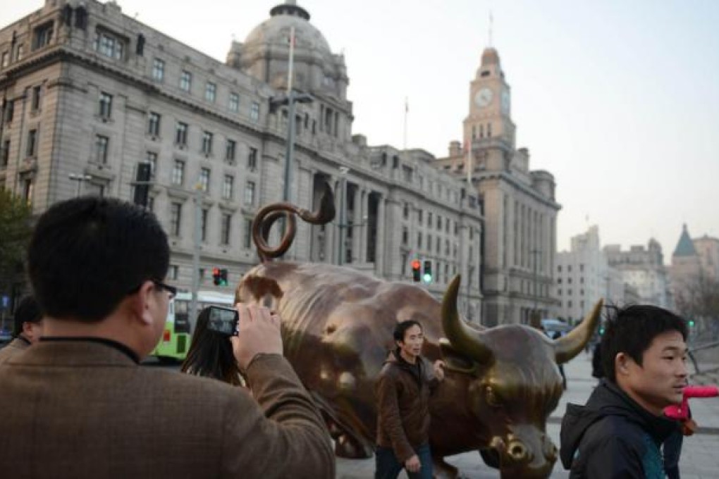 Visitors on the Bund in Shanghai. Not everyone is bullish about the mainland economy. Photo: AFP