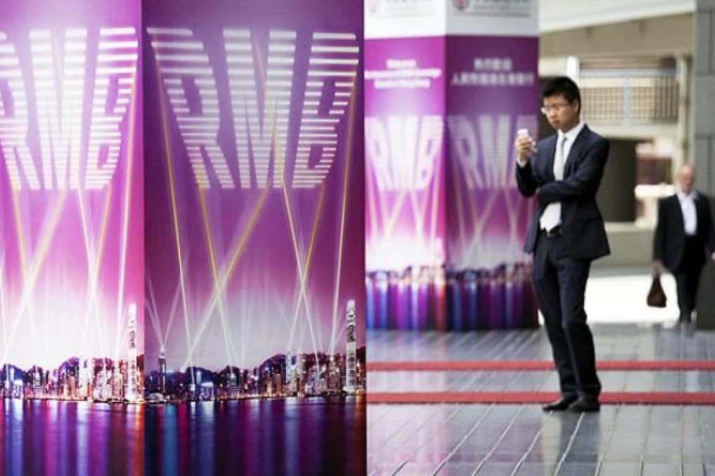 Advertisments for Renminbi bonds hang outside the Bank of China Tower in Hong Kong. Photo: Bloomberg