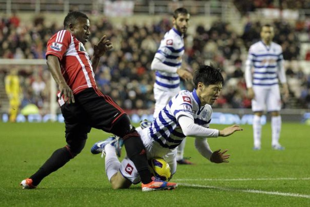 Sunderland's Stephane Sessegnon (left) vies with Queens Park Rangers' midfielder Park Ji-Sung.