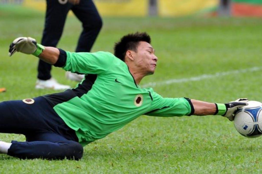 Hong Kong goalkeeper Yapp Hung-fai gets in some serious training yesterday in preparation for today's match against Guam at Mong Kok Stadium. Photo: Xinhua